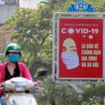 A motorcyclist drives past a poster calling people to take care of their health against the new coronavirus in Hanoi, Vietnam Tuesday, April 14, 2020. The new coronavirus causes mild or moderate symptoms for most people, but for some, especially older adults and people with existing health problems, it can cause more severe illness or death. (AP Photo/Hau Dinh)