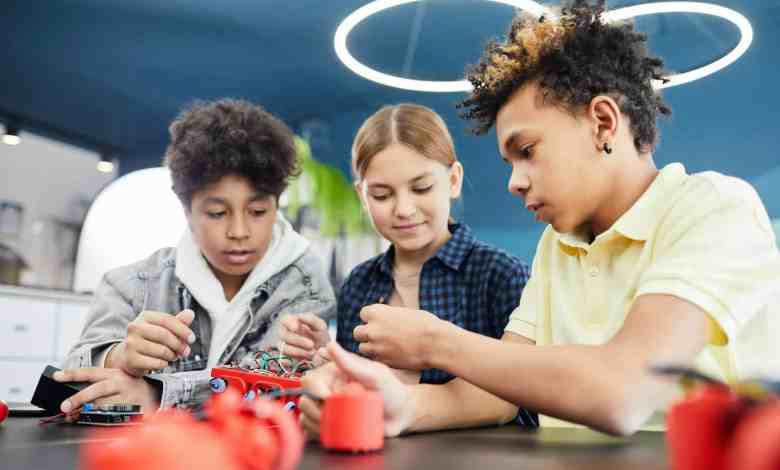 young students doing robotics together