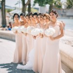 Bridal party in light pink bridesmaid dresses holding white floral bouquets at Toronto Wedding