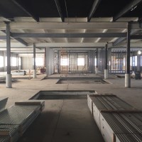 Bathroom, classrooms, and upstairs workshops framed in. Image by Will Holman.