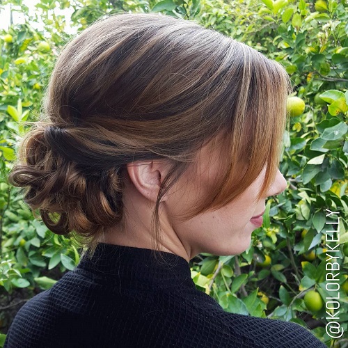 Low Curly Bun With Side Bangs