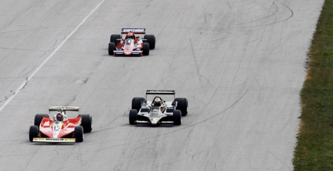 (L to R): Gilles Villeneuve (CDN) Ferrari 312T3 leads pole sitter Mario Andretti (USA) Lotus 79 away on the warm up lap of the opening start of the race. Both would jump the restart and were awarded one minute penalties, relegating them to seventh and sixth places respectively. Italian Grand Prix, Rd 14, Monza, Italy, 10 September 1978.