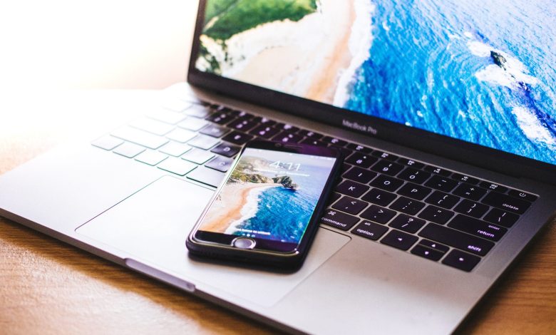 closeup photo of iPhone on MacBook Pro
