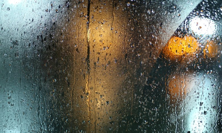 a wet window with a traffic light on it