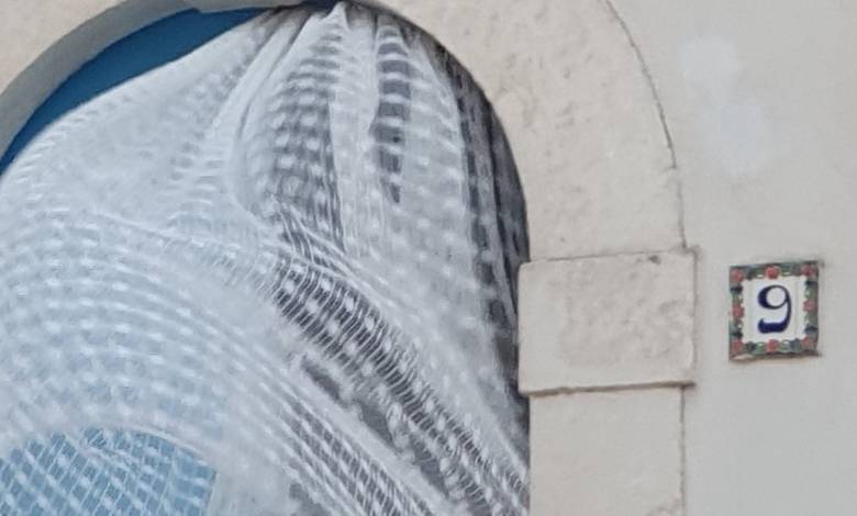 a close up of a window with a curtain on it