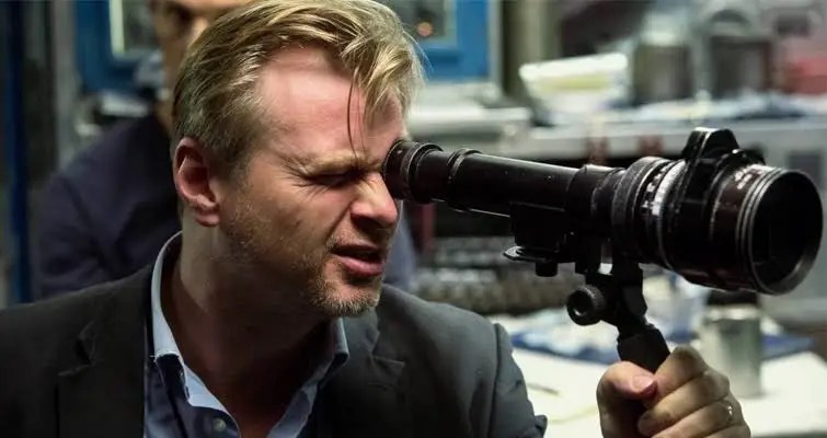 Director framing a shot using an optical viewfinder on set