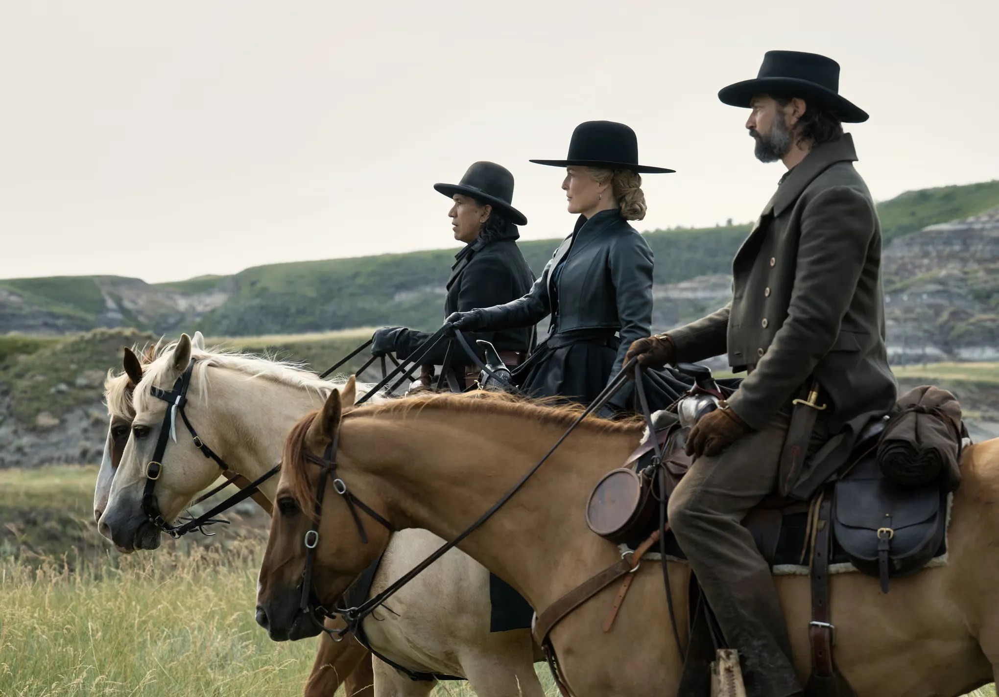 The cast of The Abandons Netflix series riding horses across the open plains of the Oregon frontier during production.