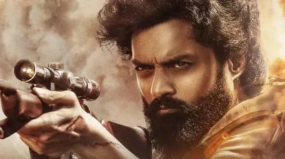 Close-up of Nandamuri Kalyan Ram aiming a sniper rifle in a dusty environment, showcasing the high-stakes action sequences analyzed in our Devil movie review.