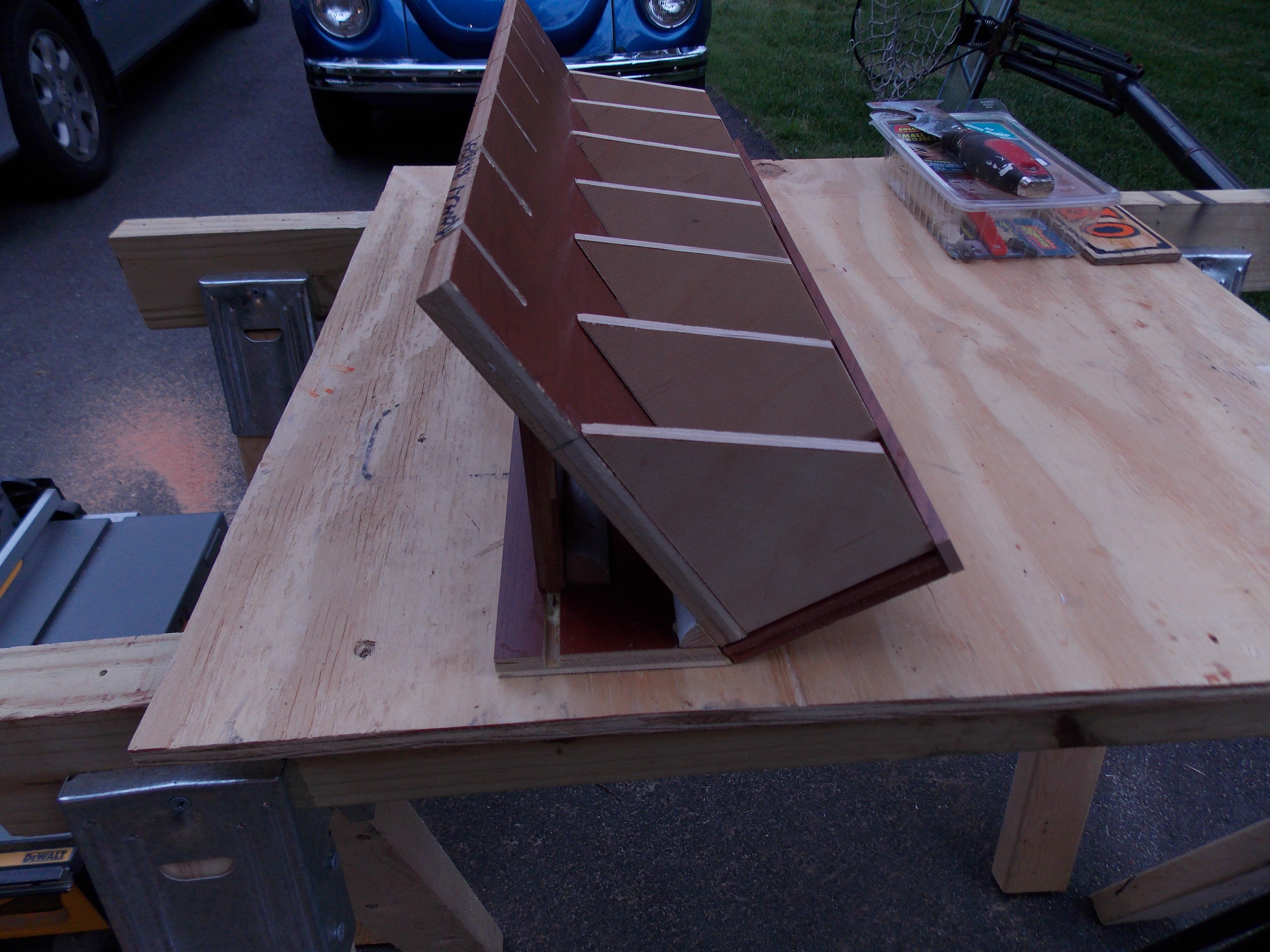 Angled back so that cell phones won't tip out.