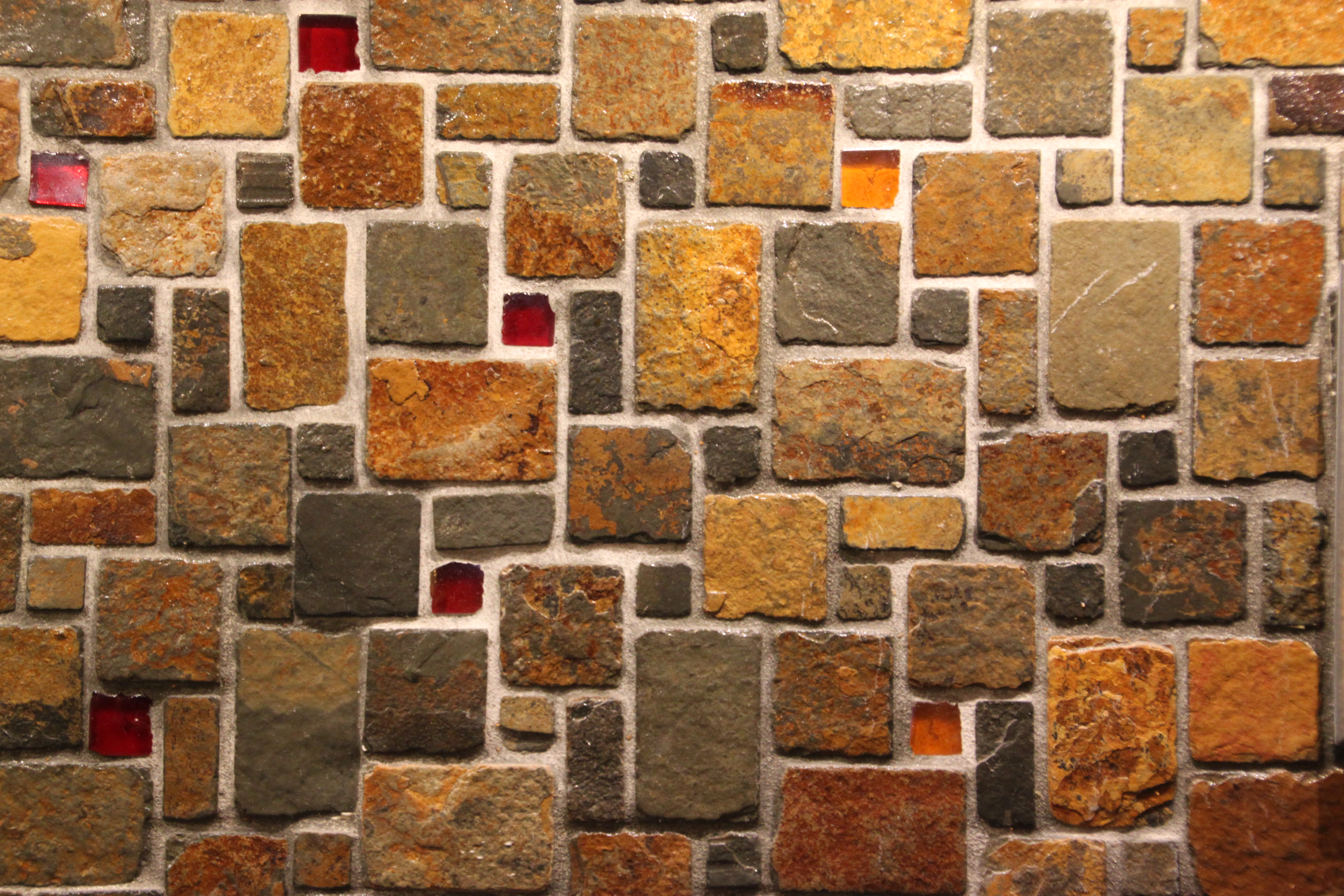 144 glass tiles were hand cut and randomly inserted into the slate mosaic as accents.