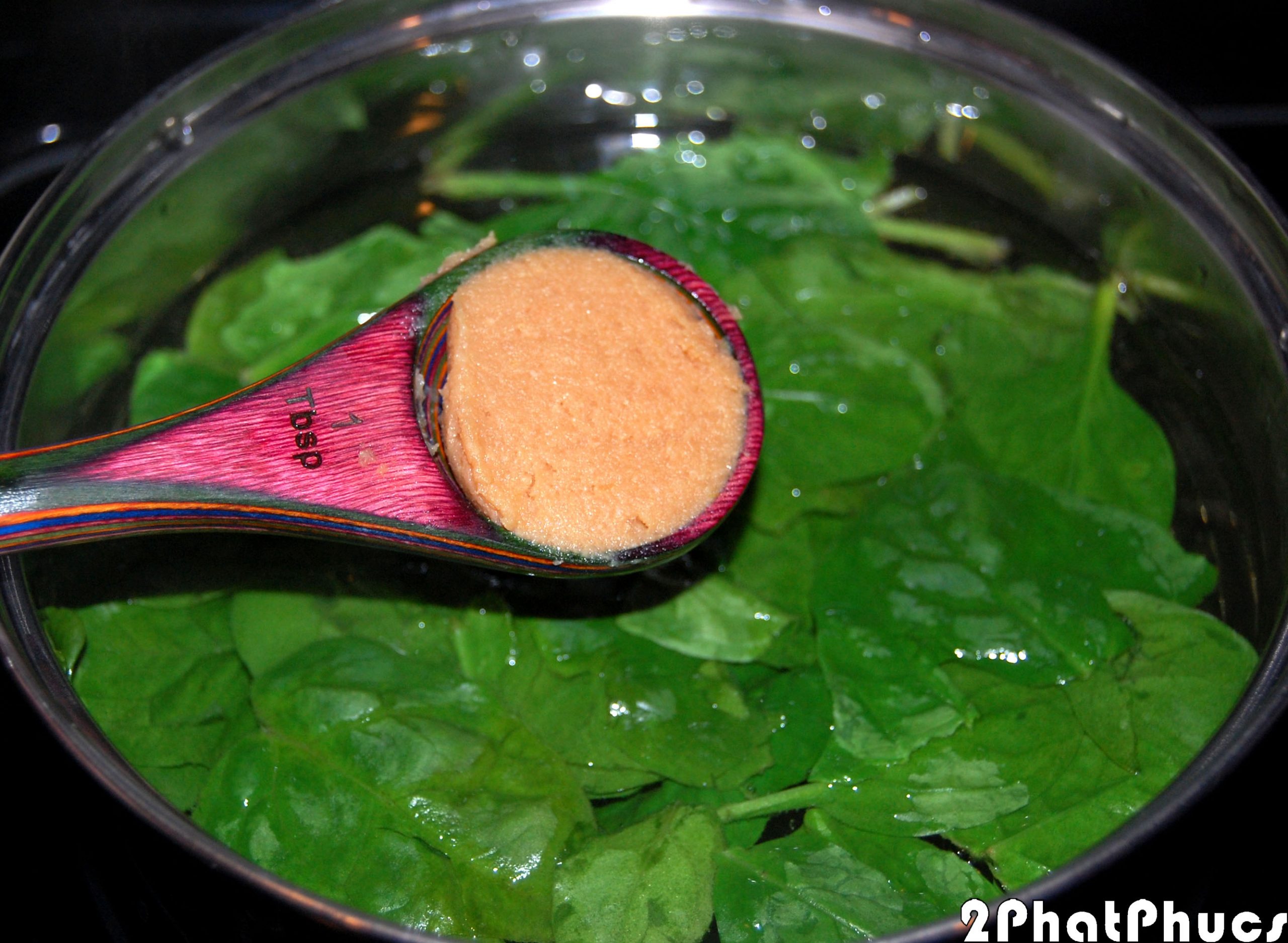 Adding miso paste to pot.