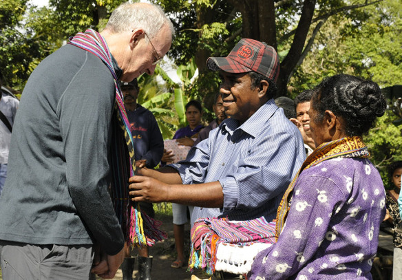 Pat is presented with a tais at a ceremony to open a new water system.