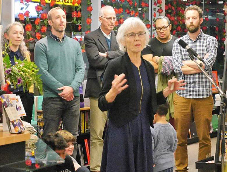 Pip's family support her while she speaks.