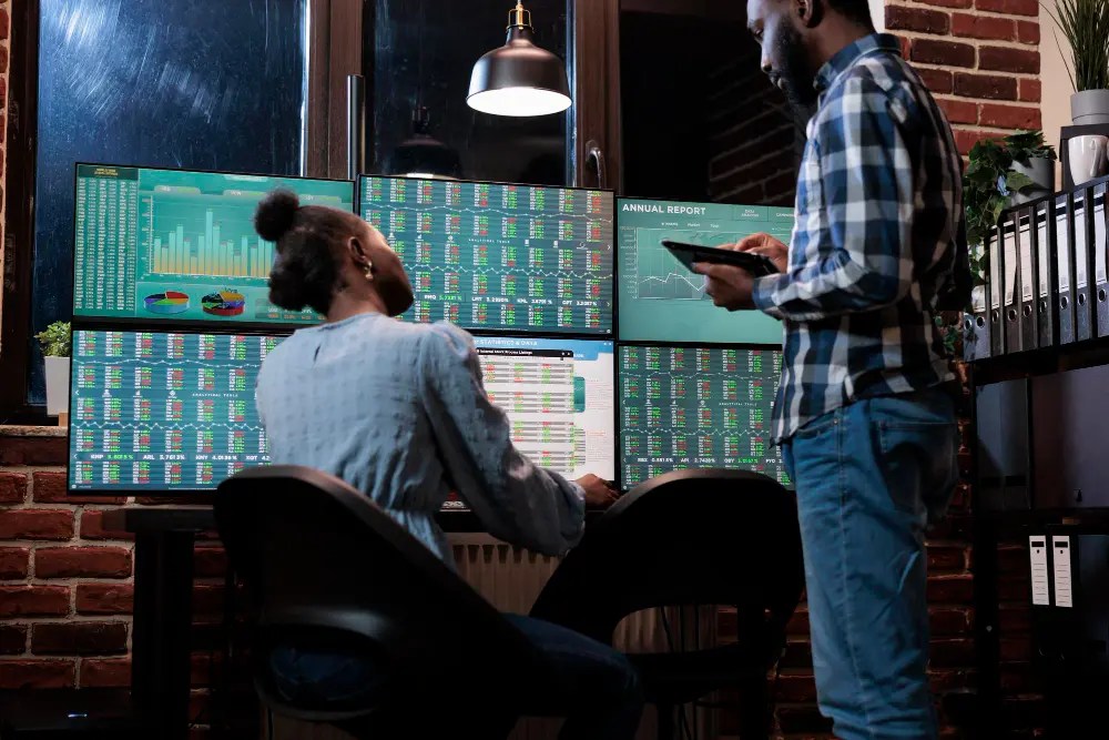 Portfolio managers reviewing market data on multiple screens to execute tax-efficient ETF rebalancing strategies
