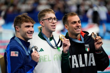 Paris Olympics Swimming Gold medalist Daniel Wiffen, center, of Ireland, poses for a photo on the podium with silver medalist Bobby Finke, of the United States, left, and bronze medalist Gregorio Paltrinieri, of Italy, following the men's 800-meter freestyle final at the 2024 Summer Olympics, Tuesday, July 30, 2024, in Nanterre, France. Courtesy: AP Photo/Ashley Landis