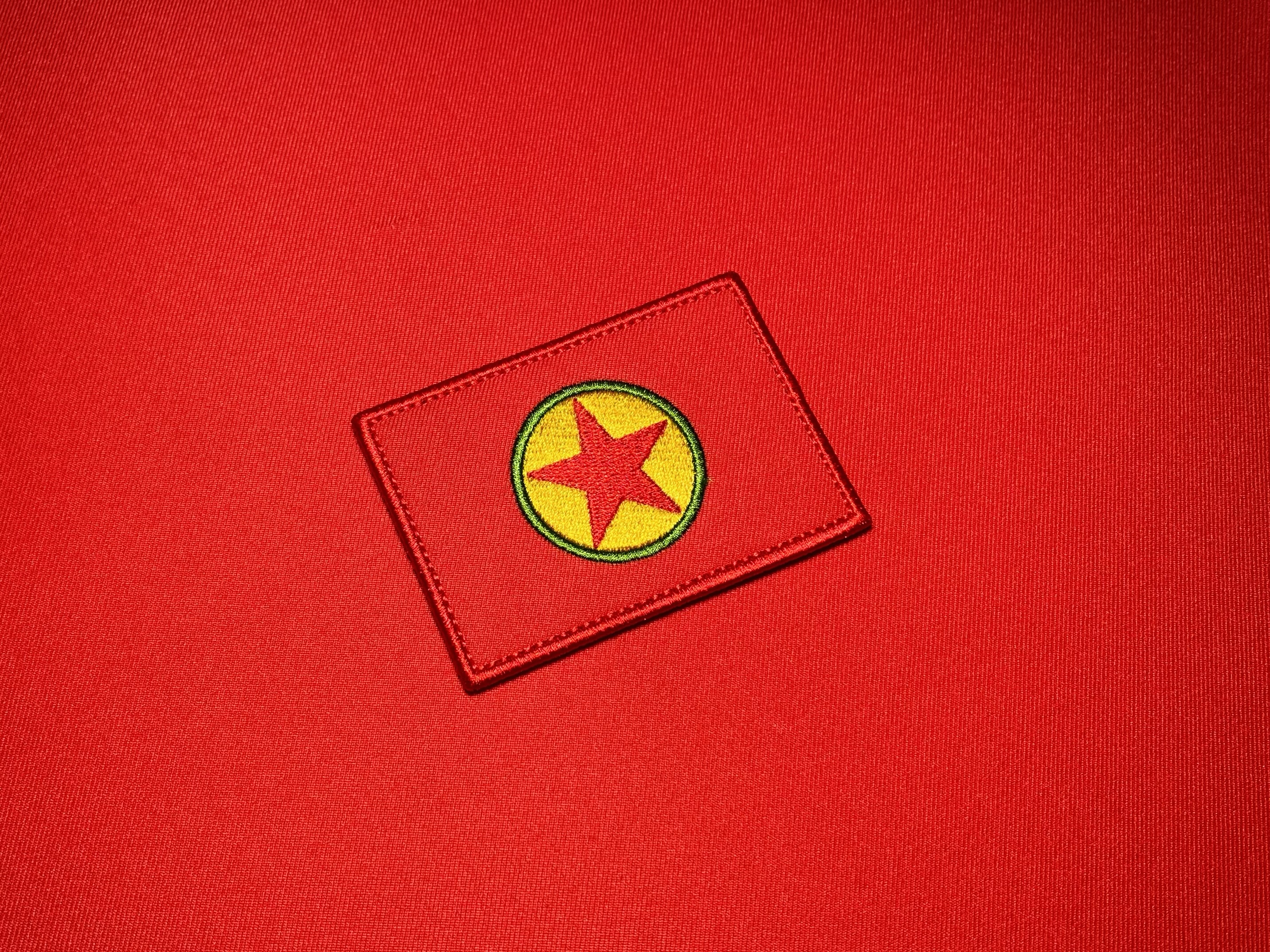 Embroidered 3.5 x 2.5 inch reproduction PKK flag patch featuring a red background with a yellow and green circular emblem and central red star.