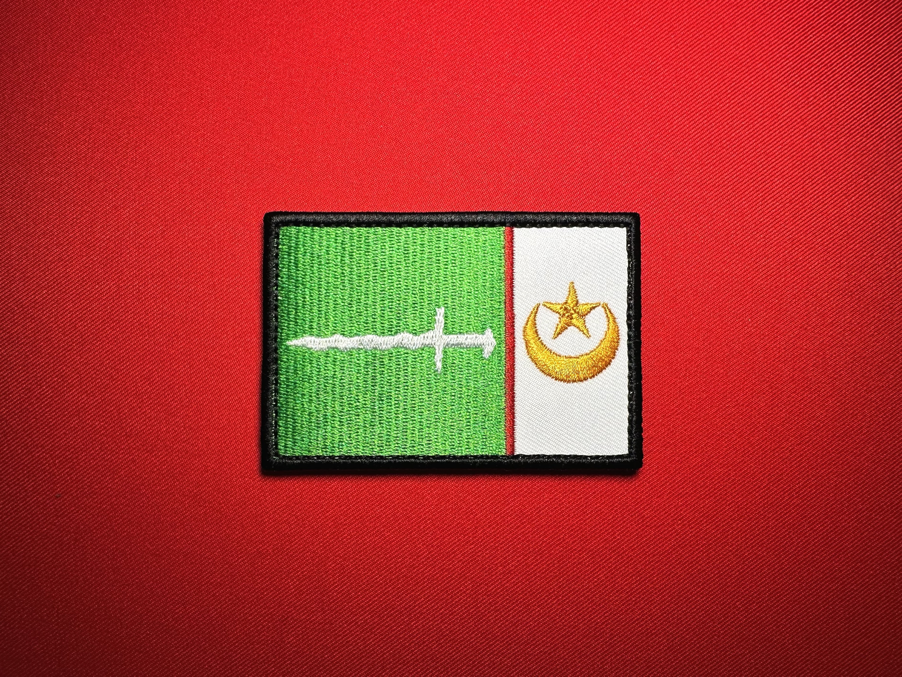 Front view of the 3.5 × 2.33-inch MILF Moro Islamic Liberation Front reproduction shoulder patch from the Philippines, showing green and white panels, a white sword, gold crescent and five-pointed star, and black edging.