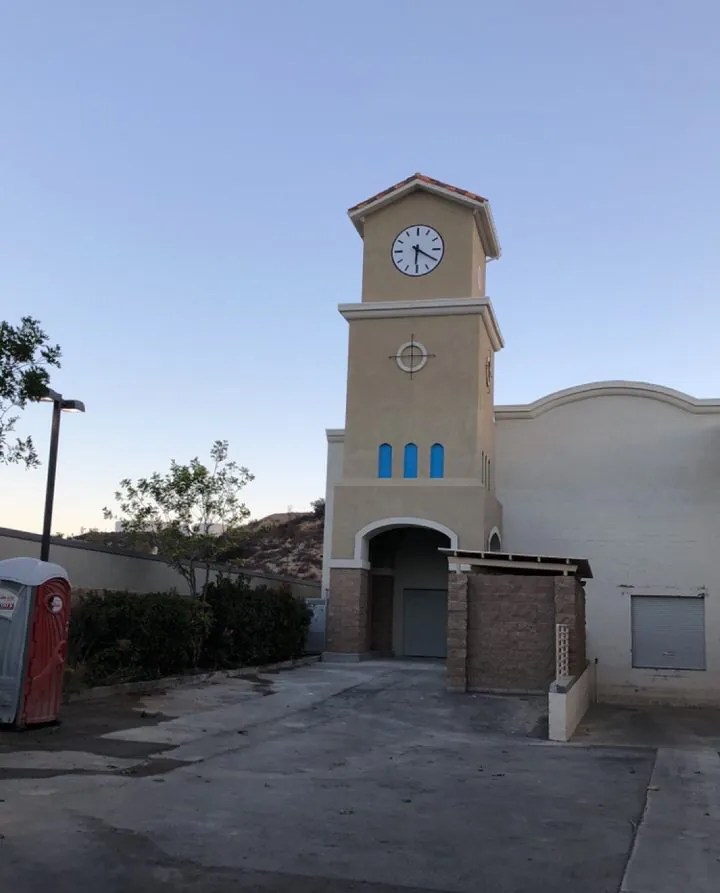 Clock tower built onto a building to conceal cell site antennas