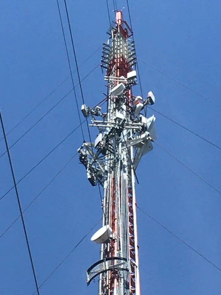 Tall lattice tower with modernized antennas, seen from below