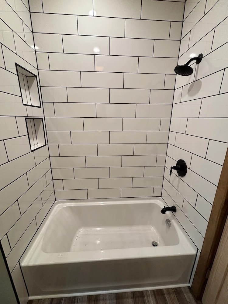 ADA accessible bathroom construction: Low tub, lovely subway tile shower walls