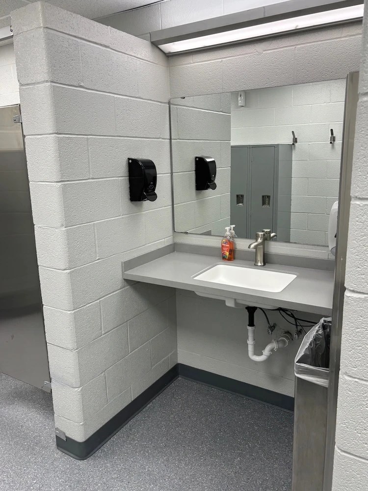 Sifco employee locker room, post-renovation: improved easy-care sink and mirror area
