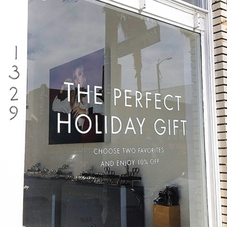Cut vinyl lettering and adhesive decals for retail window