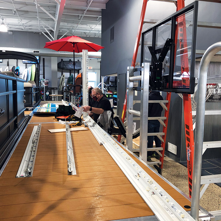 Professional installation of large SEG Fabric Light Box for boat showroom