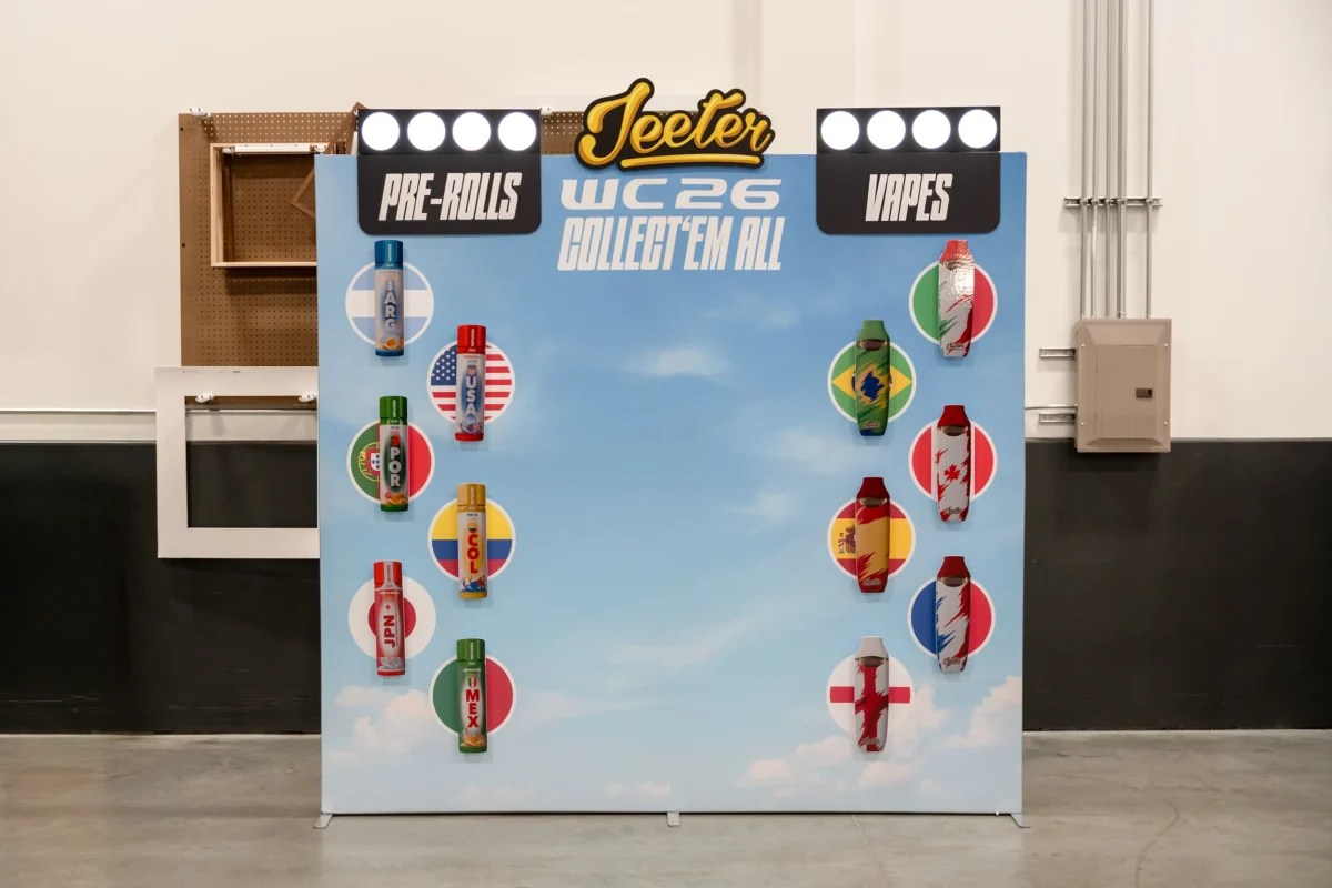 Completed Jeeter WC26 retail display with large-format printed backdrop, die-cut category signage, illuminated brand header, and mounted product fixtures