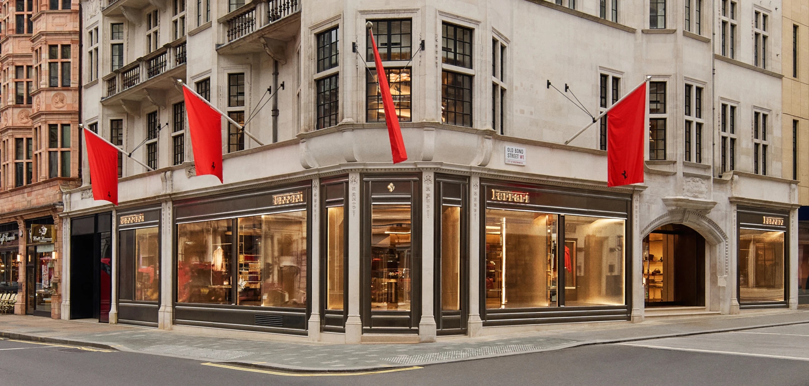 Ferrari lifestyle flagship store exterior on Old Bond Street London with red flags