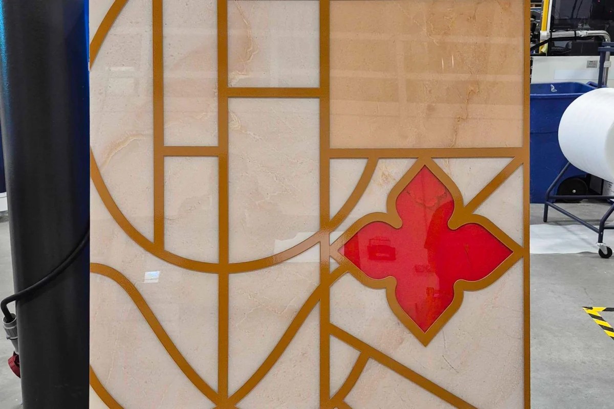 First and second surface printed acrylic signage panel with luxury marble print, gold geometric pattern, and red die-cut floral element ready for retail installation
