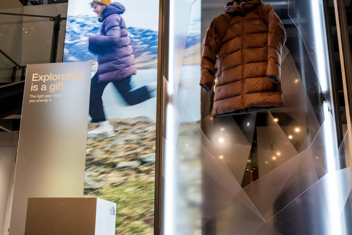 Freestanding lightbox in retail store featuring illuminated signage and backlit display graphics for The North Face product promotion