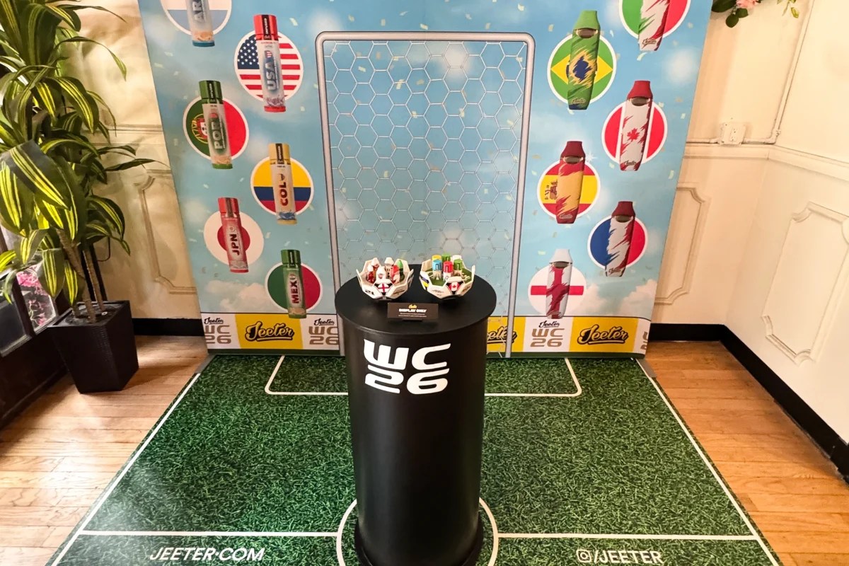 Jeeter WC26 in-store brand activation with large-format printed backdrop, branded floor graphic, vinyl-wrapped product pedestal, and category wayfinding signage