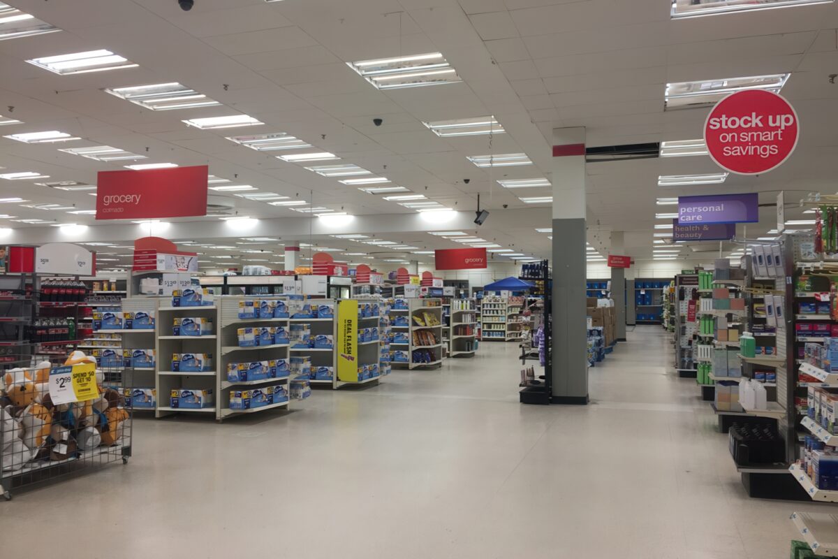 Retail store interior with outdated signage and faded promotional visuals undermining brand cohesion