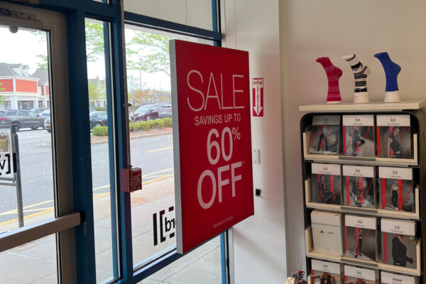 Hanging SEG signage frames in store window