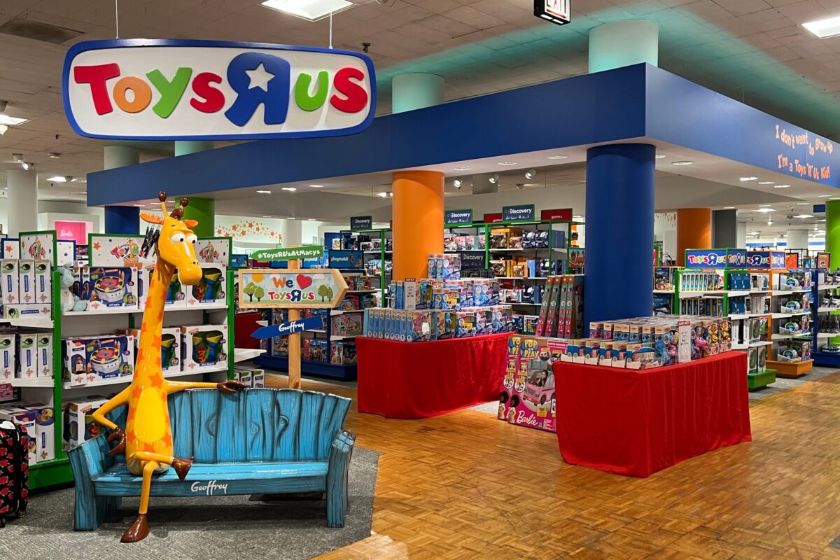 Toys R Us branded section inside Macys department store featuring colorful signage and product displays