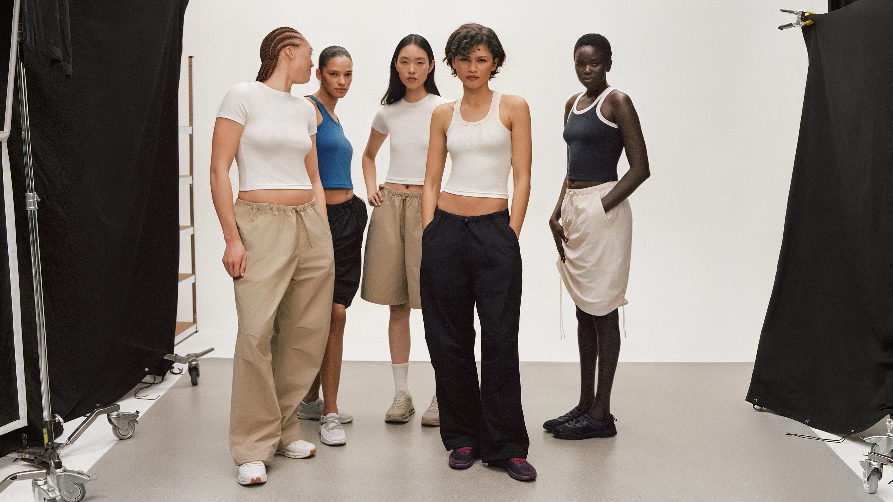 On Running and Zendaya co-created collection showing neutral-toned sportswear and footwear on studio set