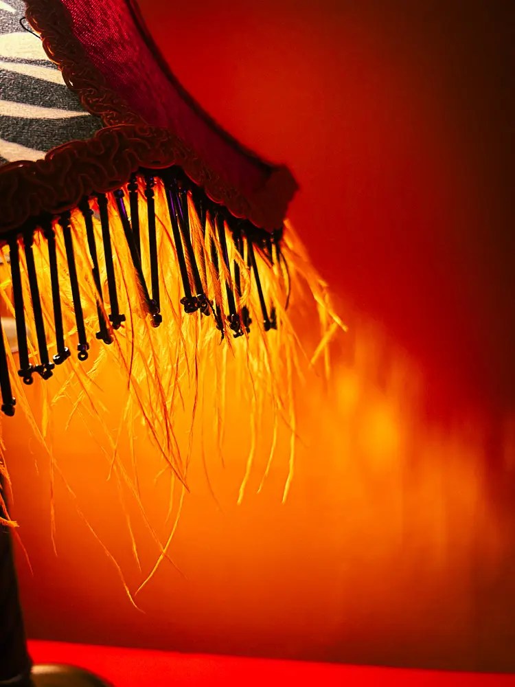 A close up of a lit lampshade embellishment shadow. 