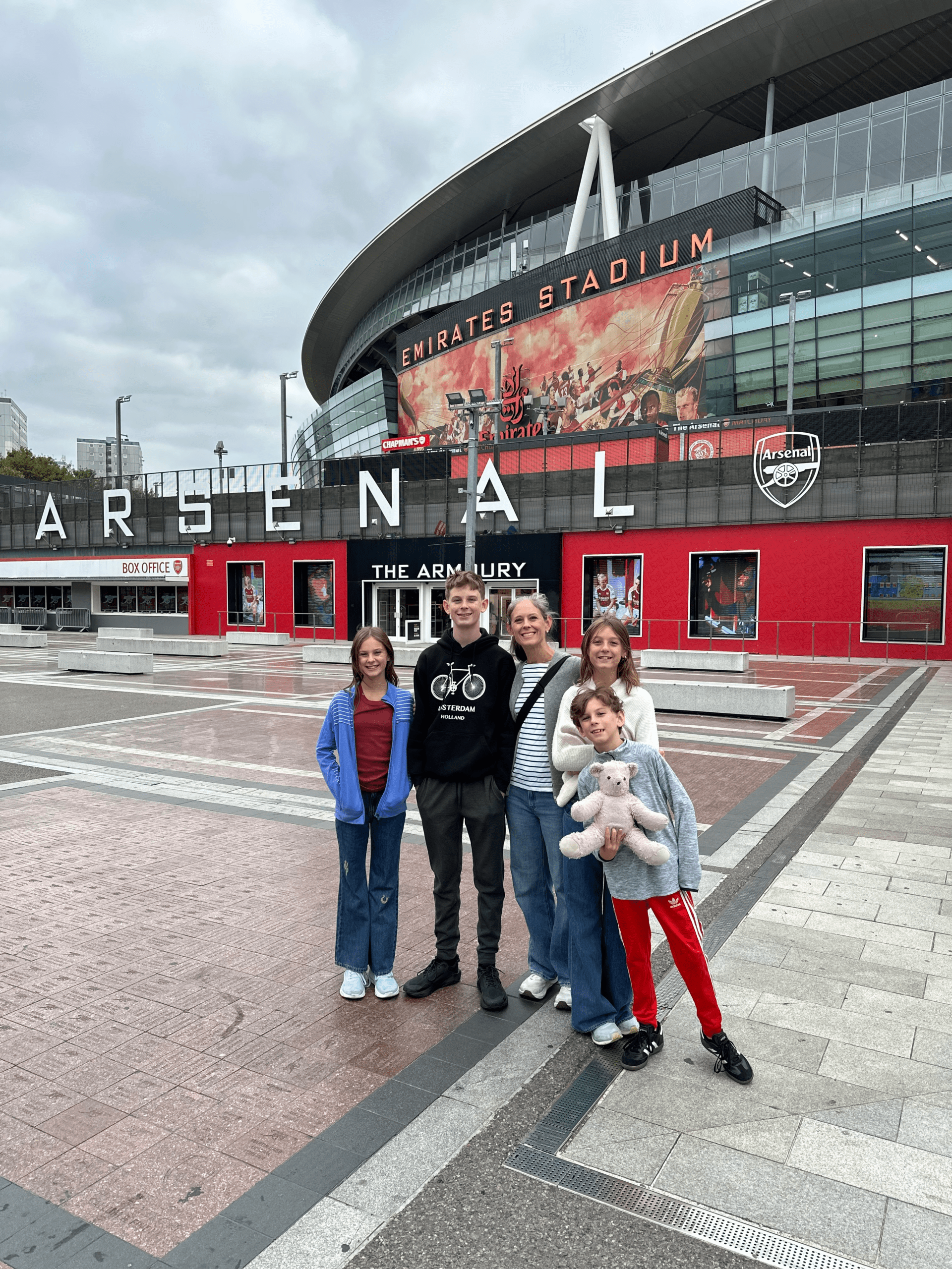 Family in front of Emirates Stadium in London