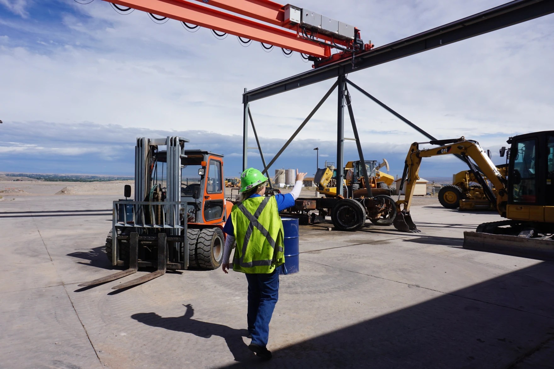 Student Destiney May, 17, points out the heavy machinery she’s learning to repair on the Wind River Job Corps campus in Riverton, Wyoming, on Sept. 17, 2026. (Hanna Merzbach/Wyoming Public Media)