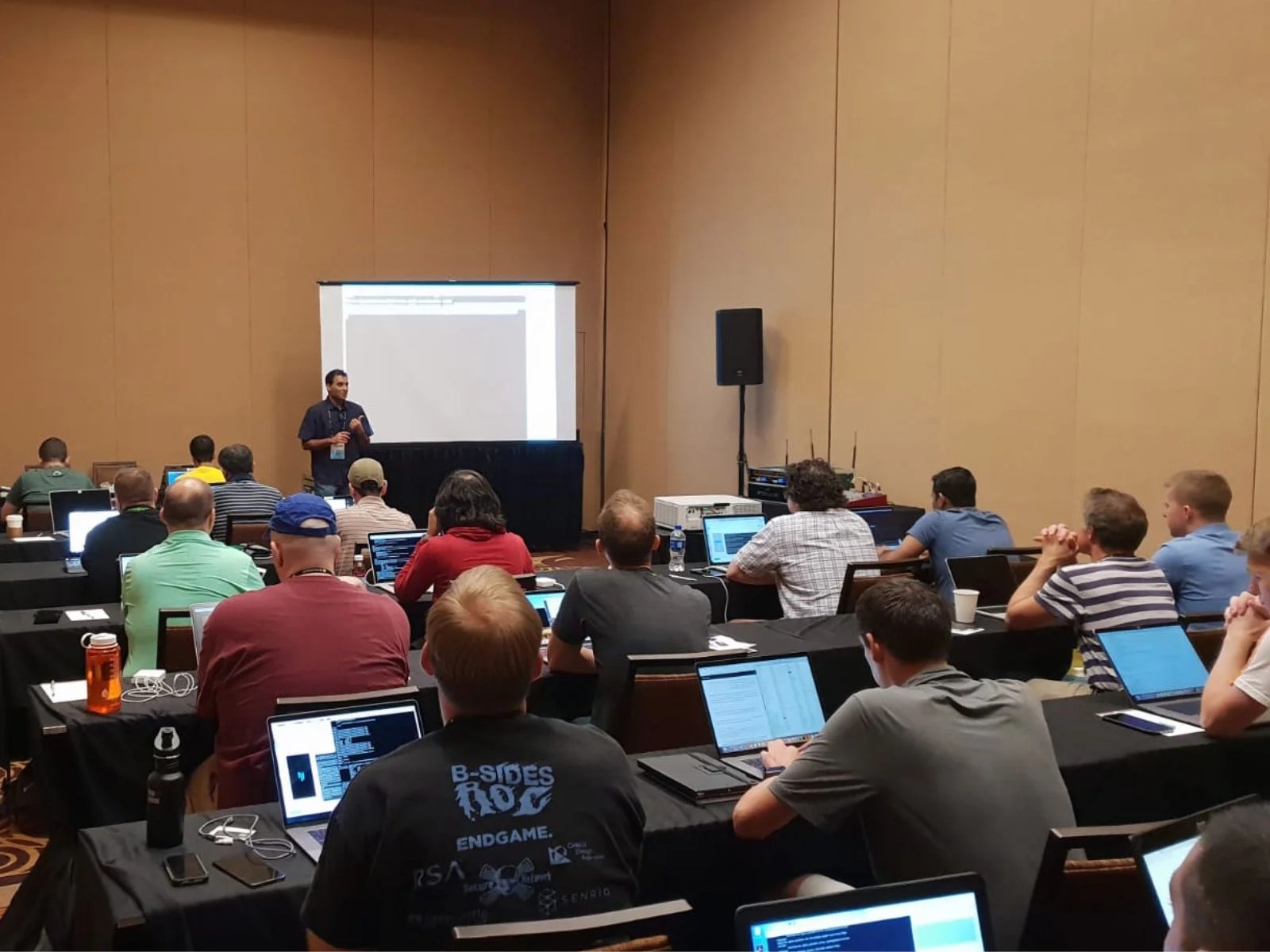 Participants in a mobile security training session watching a presentation.
