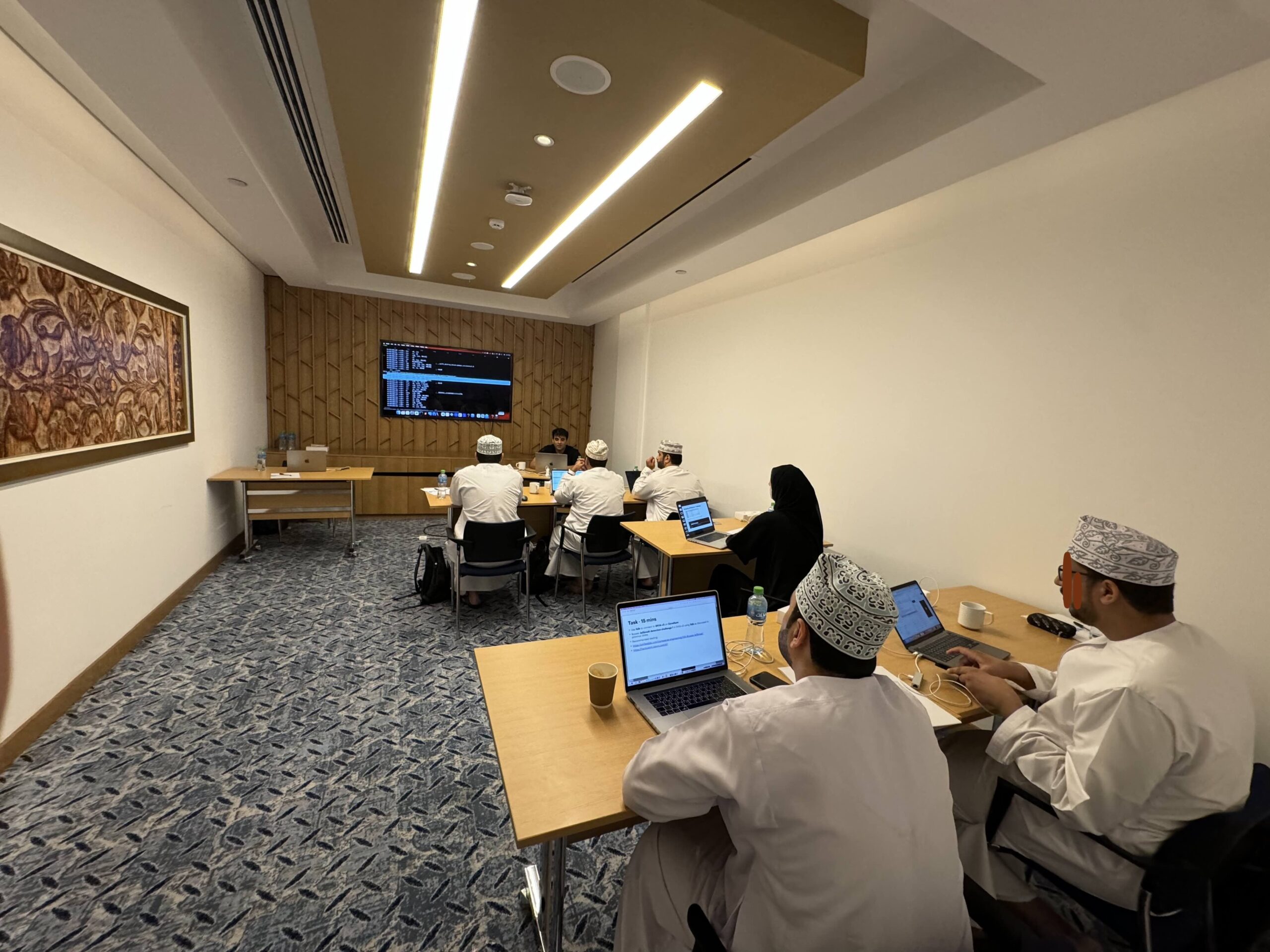 Participants taking notes during a mobile security training session.