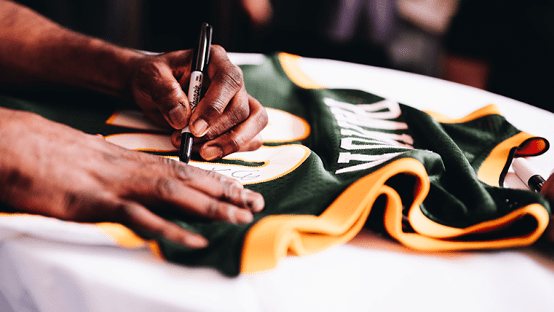 Gary Payton signing an NBA jersey activation | AW