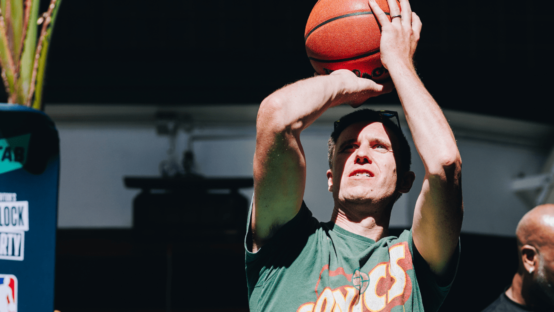 Male shooting a basketball mid shot at AW NBA event | AW