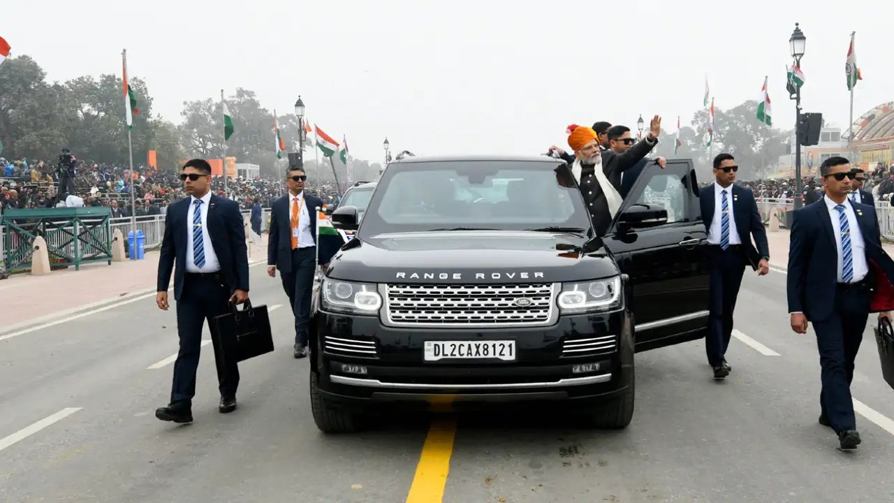 PM Narendra Modi waving from armored Range Rover Sentinel SUV during India convoy event