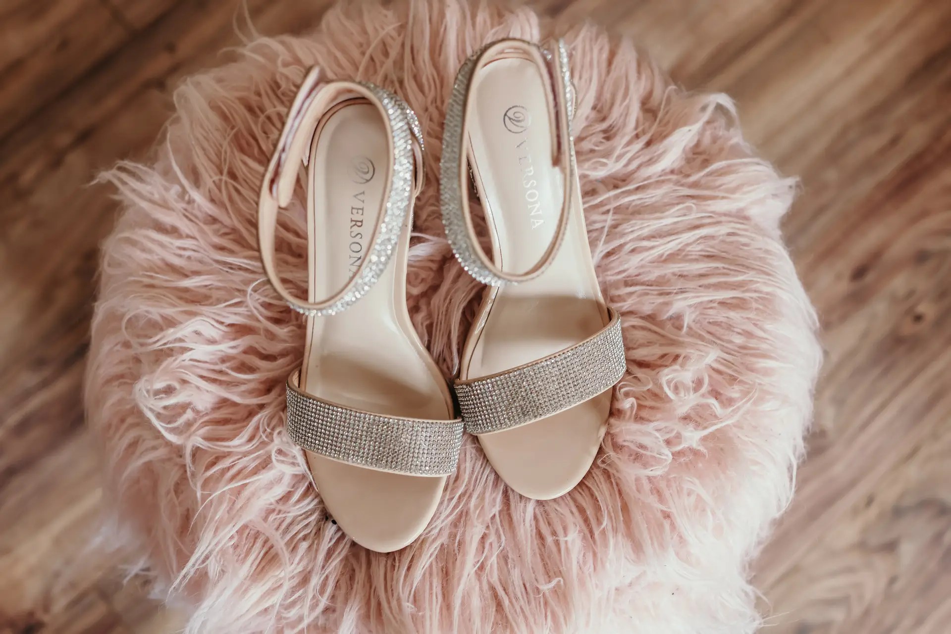 brides shoes on pink puff by North Texas Wedding Venue, The Abbey Rose