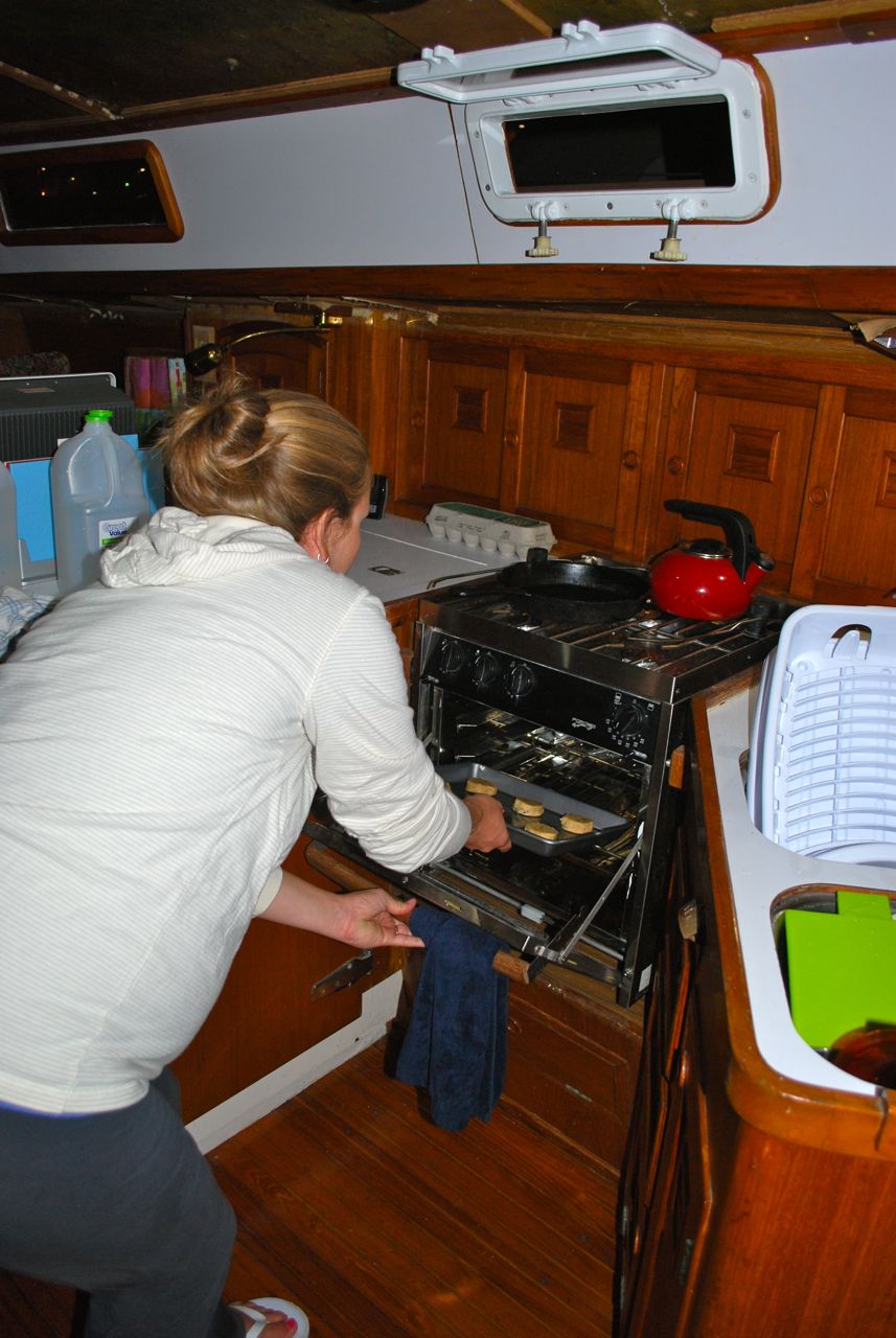 Natalie putting her first batch of cookies in the oven