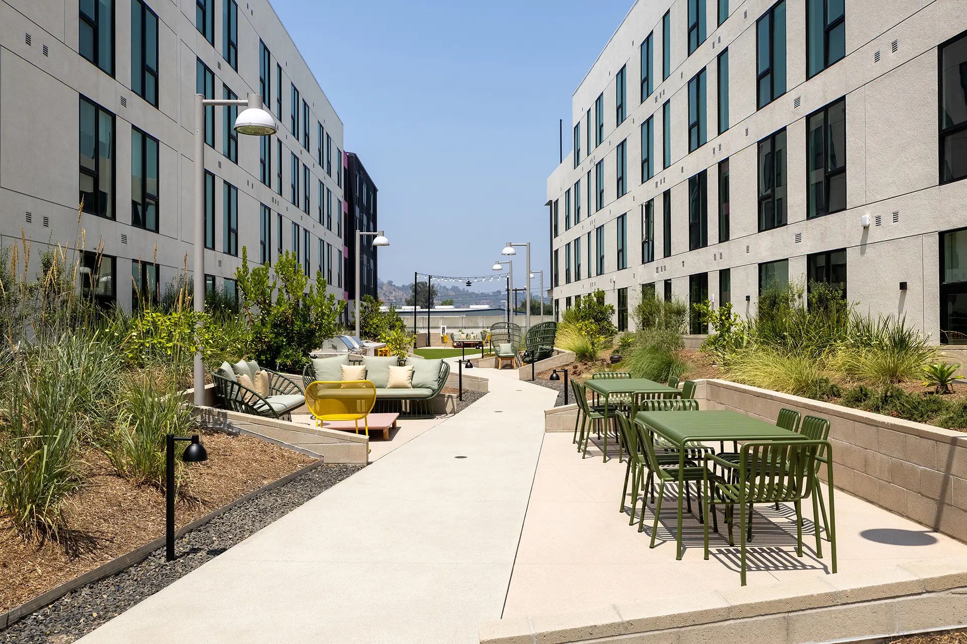 Photo of the outside common areas of the Avenue 34 Apartments, a multifamily complex in Lincoln Heights, Los Angeles, California. Services provided here include ECC verifications and tests and mechanical acceptance testing.