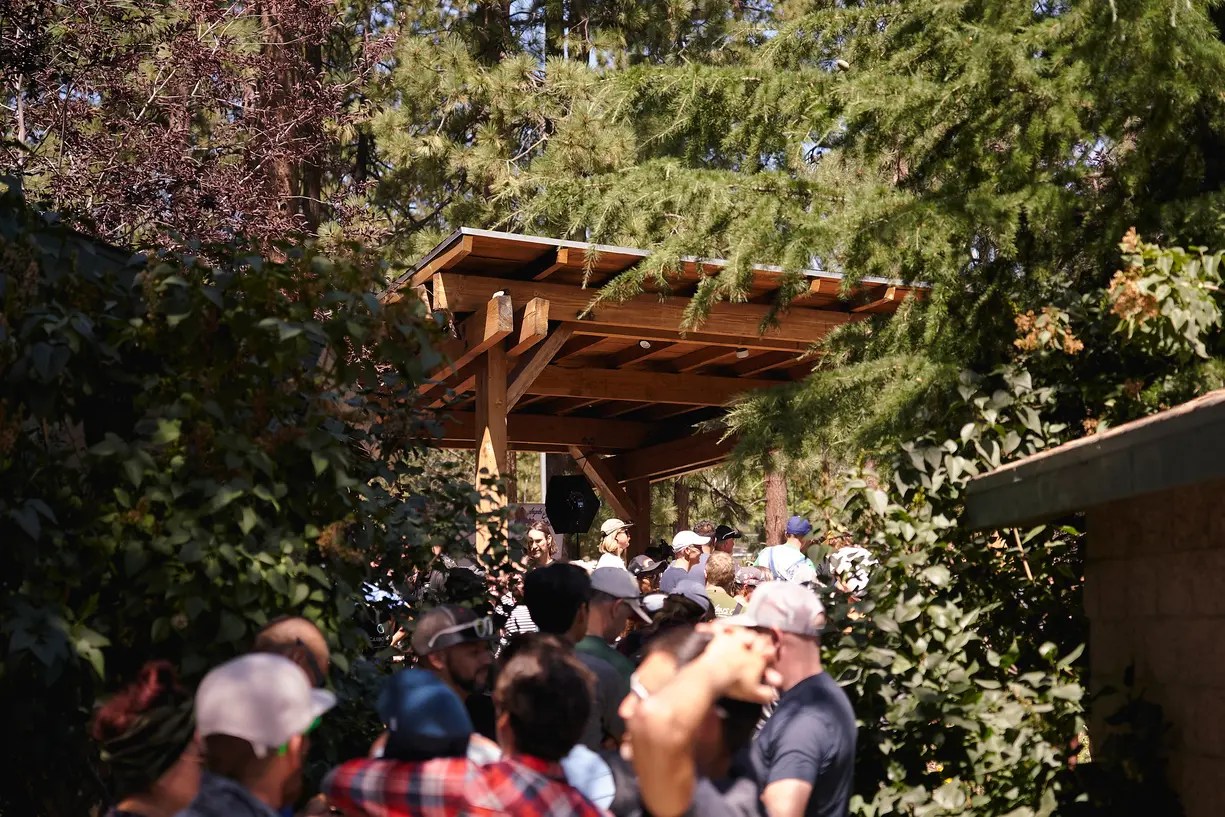 Runners line up beneath the gazebo at Wrightwood Community Center during AC100 bib check-in.