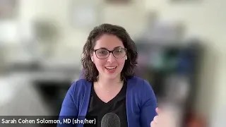 Dr. Sarah Cohen-Solomon, blue sweater, black shirt, shoulder length brown hair and glasses