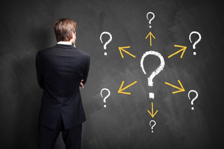 puzzled man with question marks beside him